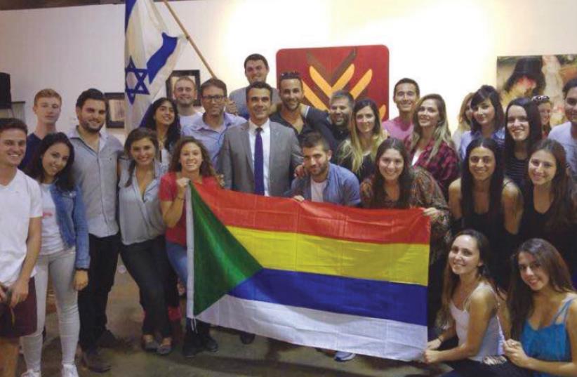 THE DELEGATION poses with Druse and Israeli flags in California. (photo credit: EINAV HALABI)
