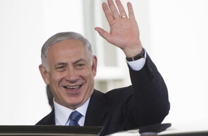 Prime Minister Benjamin Netanyahu waves after meeting President Barack Obama at the White House in Washington, October 1, 2014 (photo credit: AFP PHOTO)
