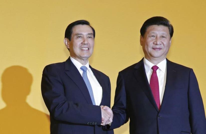 CHINESE PRESIDENT Xi Jinping shakes hands with Taiwan’s President Ma Yingjeou during a summit in Singapore on November 7. (photo credit: REUTERS)