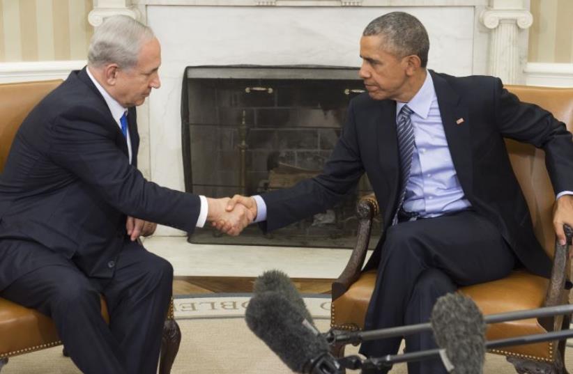 Benjamin Netanyahu shaking hands with Barack Obama at a meeting at the White House on November 9, 2015 (photo credit: SAUL LOEB / AFP)