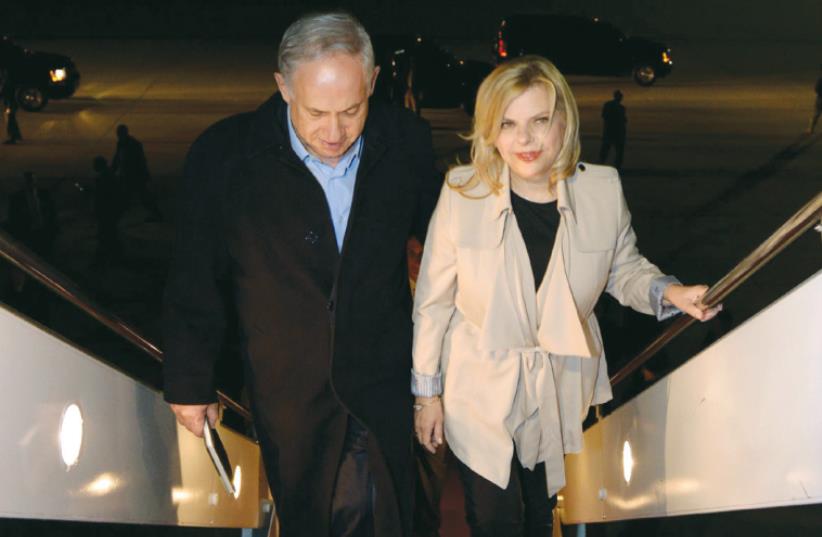 PRIME MINISTER Benjamin Netanyahu and his wife, Sara, board a plane (photo credit: HAIM ZACH/GPO)