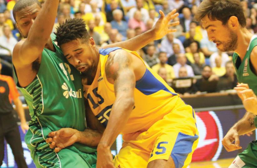 Maccabi Tel Aviv forward Sylven Landesberg (center) couldn’t help the team avoid another Euroleague defeat last night, with Darussafaka Istanbul winning 84-73 at Yad Eliyahu Arena in the first game in charge for interim coach Avi Even (inset). (photo credit: ADI AVISHAI)