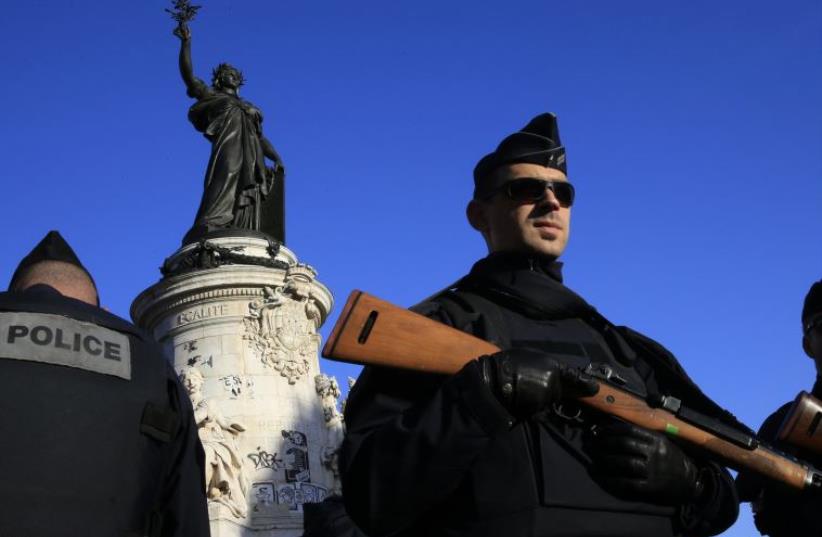 Police stand guard in Place de la Republique following the series of deadly attacks in Paris, November 15, 2015. (photo credit: REUTERS)