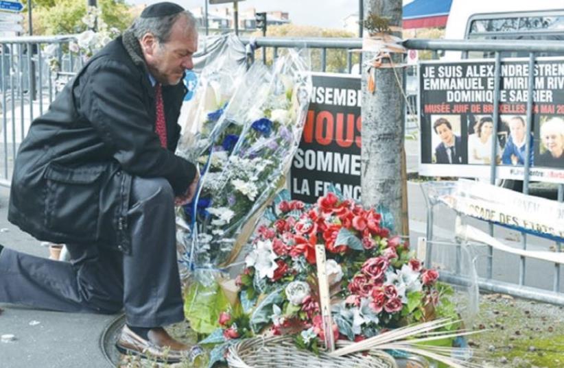 RABBI YECHIEL ECKSTEIN, president of the International Fellowship of Christians and Jews, visits a memorial site in Paris yesterday dedicated to the victims of Friday’s terrorist attacks (photo credit: Courtesy)