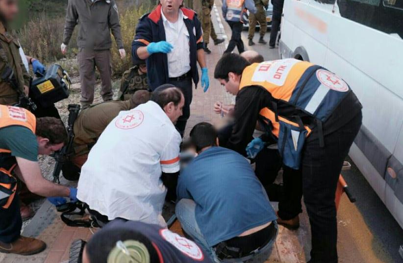 Paramedics treating victims at the scene of a terror attack in Gush Etzion in the West Bank on November 19, 2015 (photo credit: MAGEN DAVID ADOM)