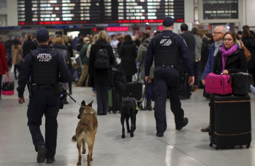Amtrak Police K-9 teams patrol a busy Pennsylvania Station in the Manhattan borough of New York City (photo credit: REUTERS)