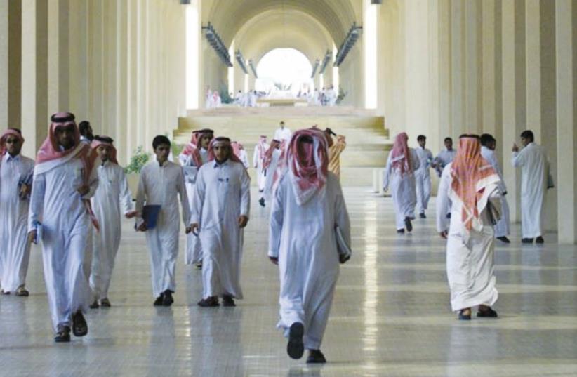 Saudi men walk through the halls of King Saud University in Riyadh (photo credit: MAARIV HAMUSAF)