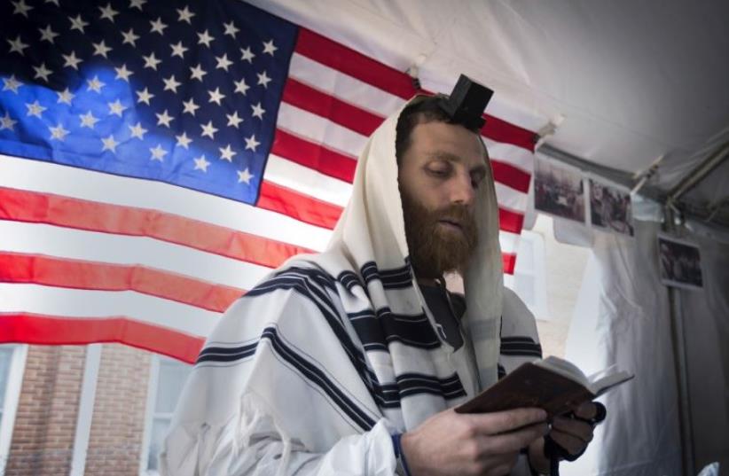 An American Jewish man praying  (photo credit: REUTERS)