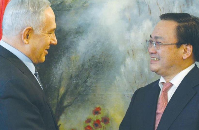 PRIME MINISTER Benjamin Netanyahu greets Vietnamese Deputy Prime Minister Hoang Trung Hai at the Knesset this week. (photo credit: KOBI GIDEON/GPO)