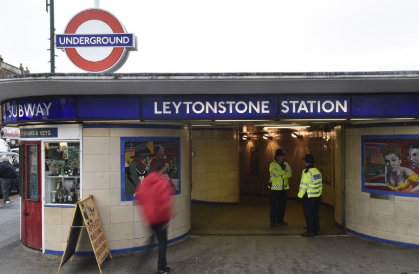 Police officers stand on duty outside Leytonstone Underground station in east London, December 7, 2015.  (photo credit: REUTERS)