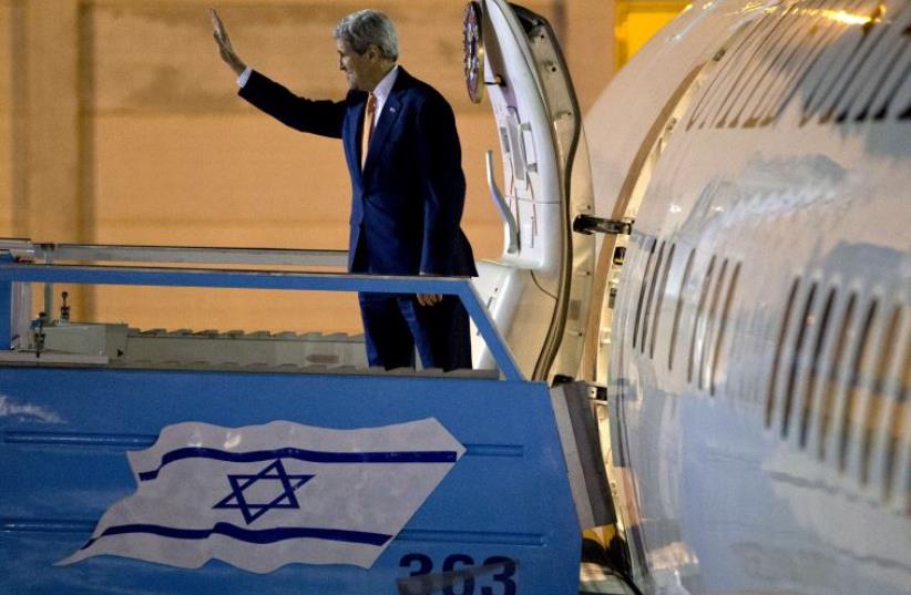 US Secretary of State John Kerry waves as he heads home after a visit to Israel and the Palestinian Authority, November 24 (photo credit: REUTERS)