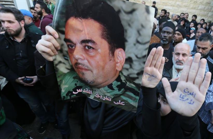Lebanese mourners hold portraits of Lebanese militant Samir Kantar during his funeral procession (photo credit: AFP PHOTO)