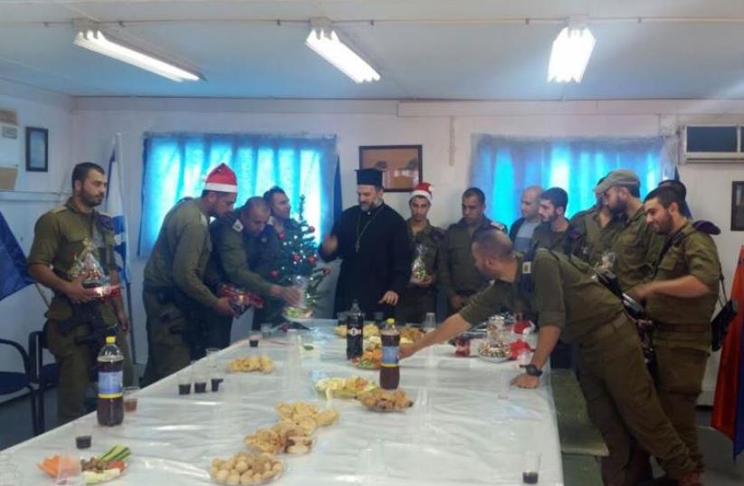 Father Naddaf of Nazareth with Christian Israeli IDF soldiers at a Christmas party on December 21, 2015 (photo credit: ISRAELI CHRISTIAN RECRUITMENT FORUM)