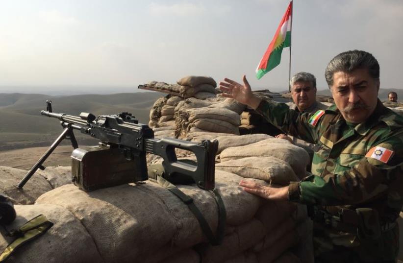 Hussein Yazdanpana, vice-president of the Kurdistan Freedom Party (PAK) gestures as he shows the frontline position his soldiers occupy fighting Islamic State northwest of Kirkuk (photo credit: SETH J. FRANTZMAN)