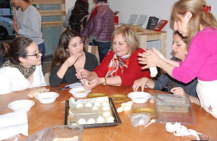 Baking cookies with the women of the Rameh Orthodox Christian Church. (photo credit: MEDIA LINE)