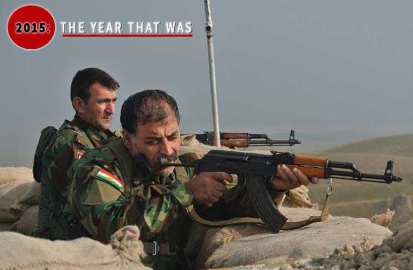 Two Kurdish members of the Kurdistan Freedom Party (PAK) look through their gun sights toward Islamic State positions on the front lines northwest of Kirkuk (photo credit: JPOST STAFF,SETH J. FRANTZMAN)