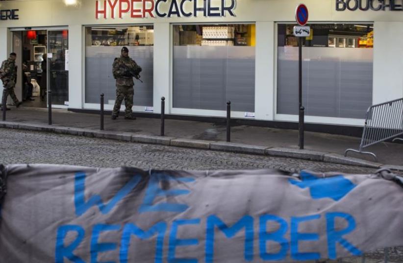 A French soldier patrols outside the Hypercacher kosher supermarket in Paris (photo credit: REUTERS)