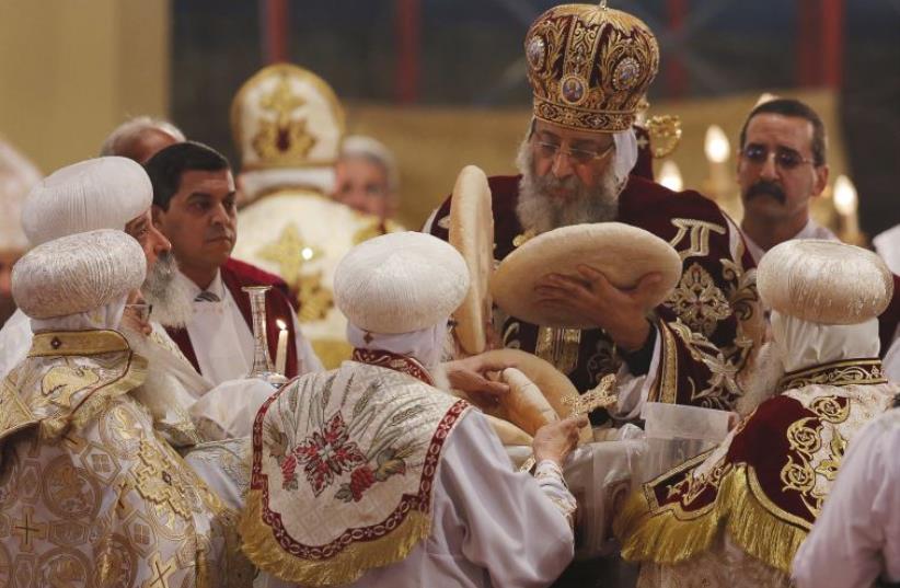 Pope Tawadros II, the 118th Pope of the Coptic Orthodox Church of Alexandria and Patriarch of the See of St. Mark Cathedral, leads Egypt's Coptic Christmas eve mass in Cairo, Egypt, January 6, 2016 (photo credit: REUTERS)