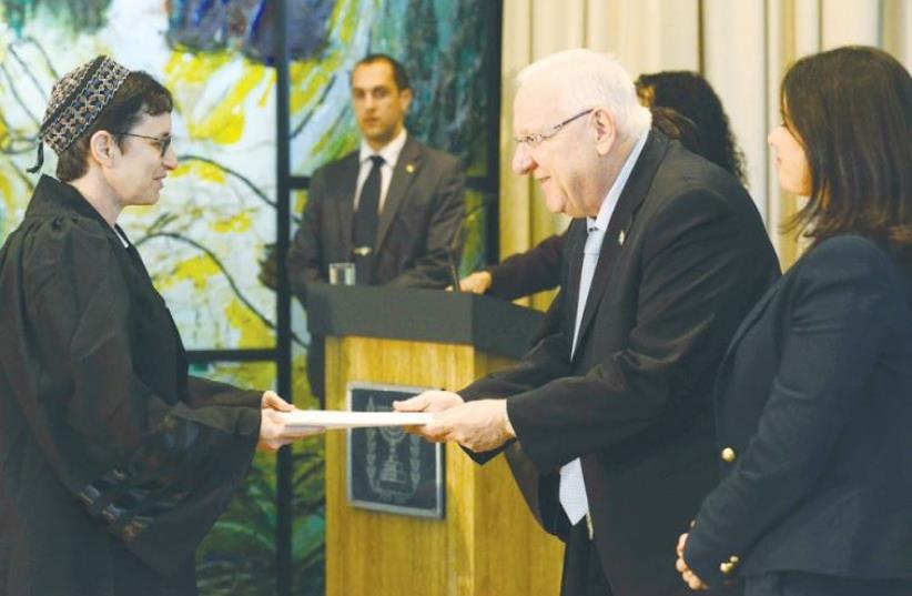 PRESIDENT REUVEN RIVLIN officiates at the swearing-in of 21 newly appointed judges and court registrars at his residence (photo credit: GPO)