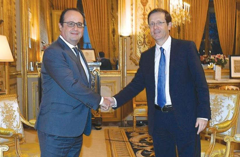 FRENCH PRESIDENT François Hollande welcomes opposition leader MK Isaac Herzog to Paris on Friday. (photo credit: EREZ LICHTFELD)