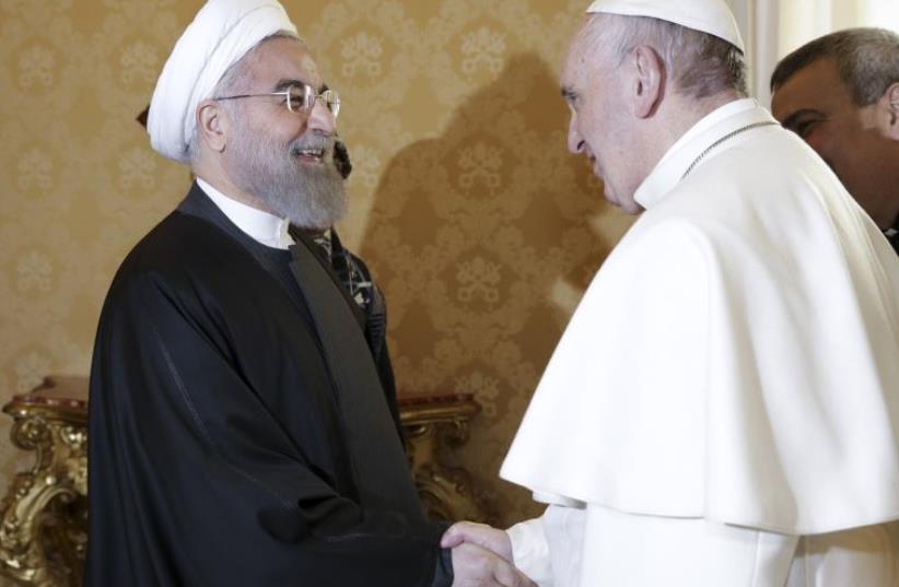 Iran's President Hassan Rouhani (L) is welcomed by Pope Francis at the Vatican January 26, 2016 (photo credit: REUTERS)