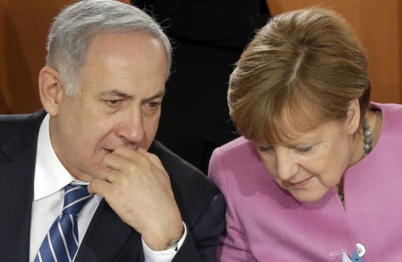 German Chancellor Angela Merkel and Israeli Prime Minister Benjamin Netanyahu speak before a lunch as part of a one day governmental meeting at the Chancellery in Berlin, Germany, February 16, 2016 (photo credit: REUTERS)