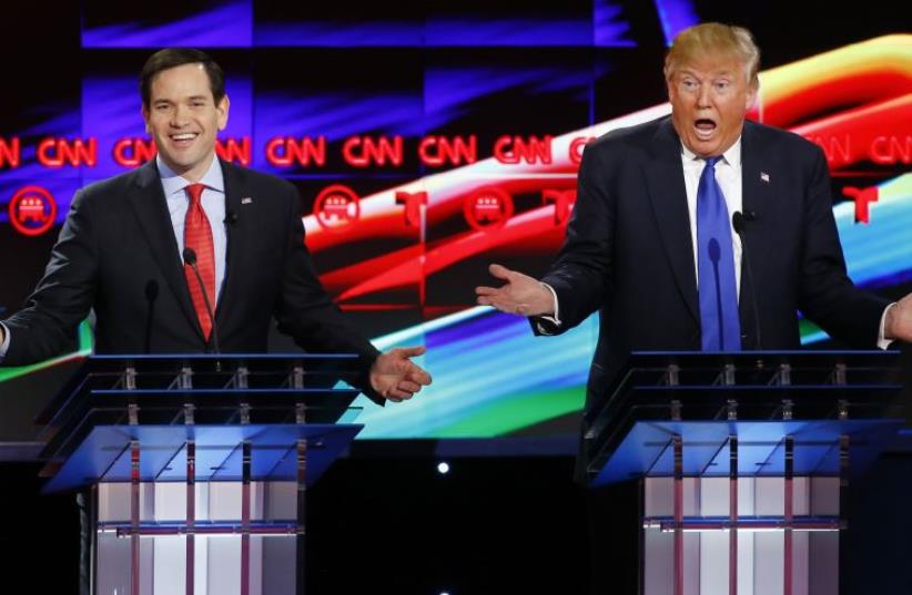 Republican US presidential candidates Marco Rubio (L) and Donald Trump speak simultaneously at the debate sponsored by CNN for the 2016 Republican US presidential candidates in Houston, Texas, February 25, 2016. (photo credit: REUTERS)