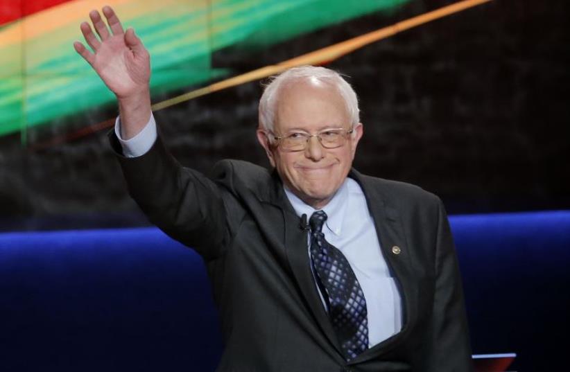 Democratic US presidential candidate and U.S. Senator Bernie Sanders waves at the start of the Democratic U.S. presidential candidates' debate in Flint, Michigan, March 6, 2016 (photo credit: REUTERS)