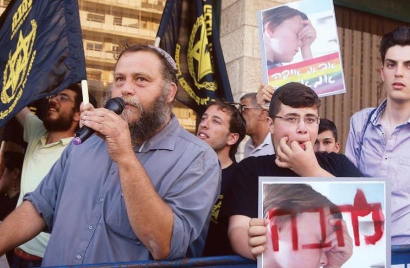Sparring: Members of the Lehava movement protest. A sign reads, ‘Father, where is my mother?’ (photo credit: MARC ISRAEL SELLEM)