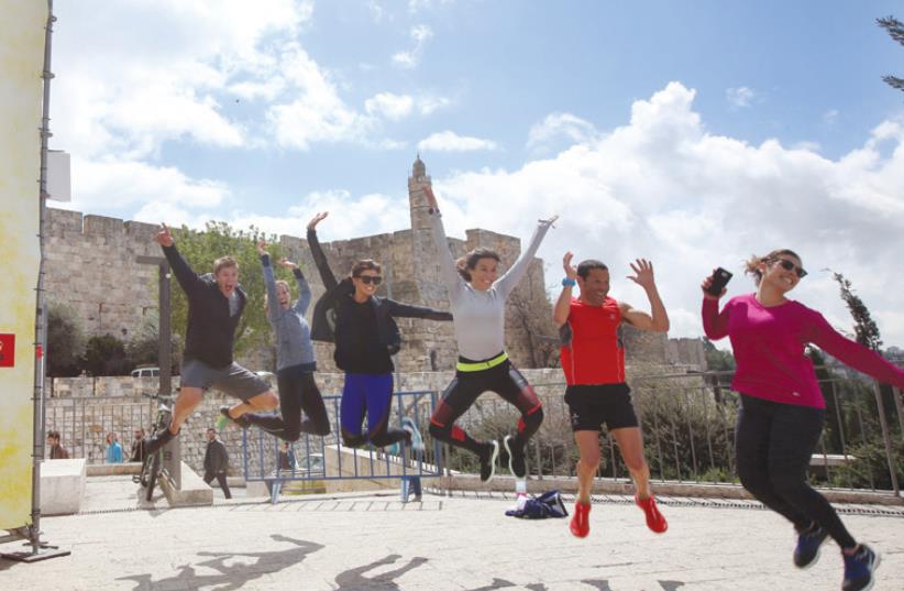 US ACTRESS Rachele Brooke Smith (third left) and friends get ready for the Jerusalem Marathon near Jaffa Gate yesterday. (photo credit: MARC ISRAEL SELLEM/THE JERUSALEM POST)