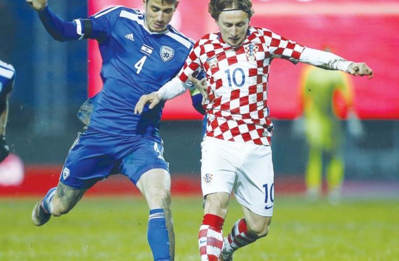 Israel midfielder Nir Biton (left) battles Croatia’s Luka Modric for the ball during last night’s 2-0 defeat in an international friendly in Osijek (photo credit: REUTERS)