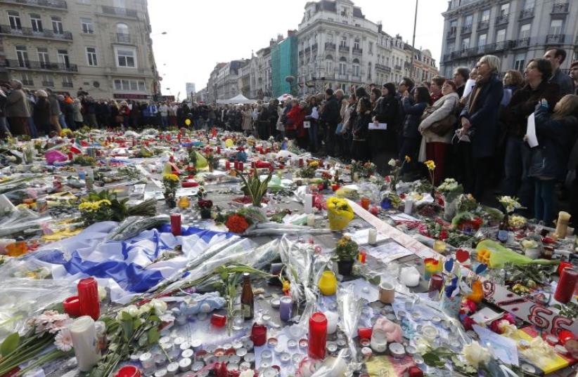 People gather at a street memorial in Brussels following Tuesday's bombings in Brussels (photo credit: REUTERS)