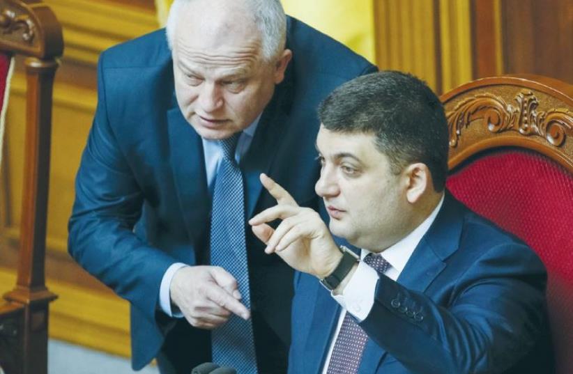 UKRAINIAN PARLIAMENT SPEAKER Volodmyr Groysman (right) speaks with Stepan Kubiv, President Petro Poroshenko’s representative in parliament, during a session in Kiev on March 29. (photo credit: GLEB GARANICH/REUTERS)