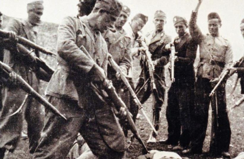 VICTIMS OF the Nazi-backed Ustasha regime killed at the end of the World War Two lay on the ground surrounded by posing Ustasha soldiers near the Sava river in Croatia in 1945. (photo credit: REUTERS)