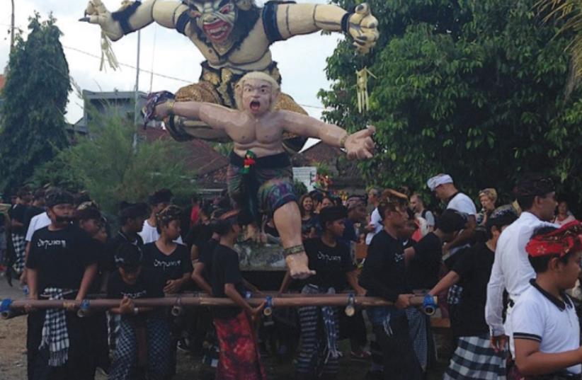OGOH-OGOH, a towering effigy of demons and evil spirits, is carried down the street in Uluwatu. (photo credit: JANE MEDVED)
