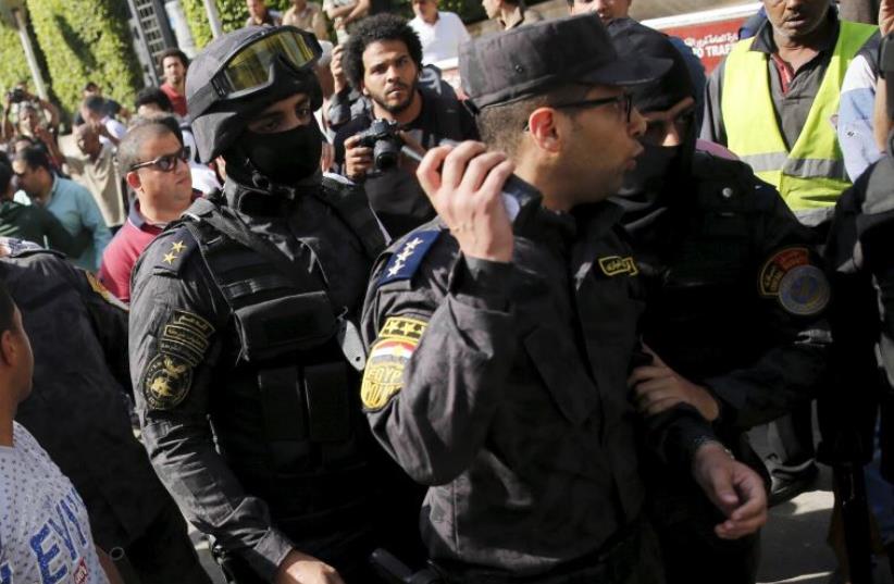 Egyptian protesters shout slogans and argue with police during a demonstration  (photo credit: REUTERS)