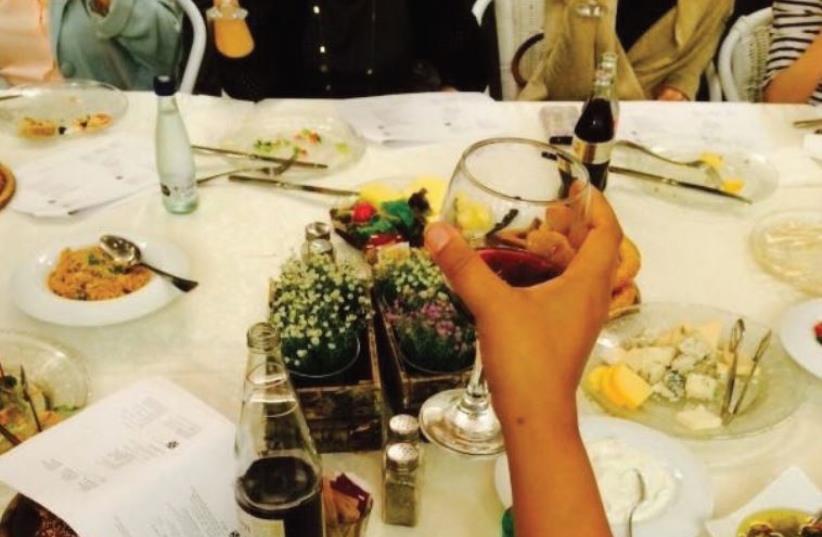 Raising a glass at the Turning the Tables Seder (photo credit: TTT)