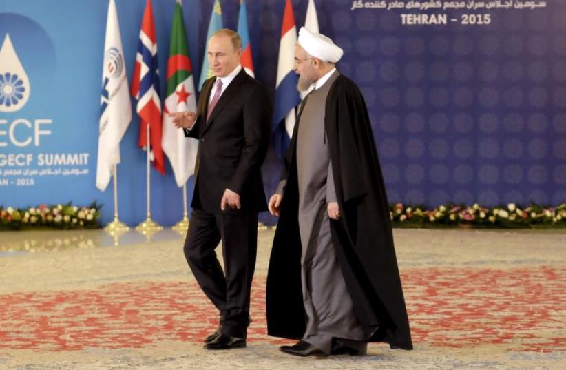 Iran's President Hassan Rouhani (R) walks with Russia's President Vladimir Putin before a meeting during the Gas Exporting Countries Forum (GECF) in Tehran, November 23, 2015 (photo credit: REUTERS)