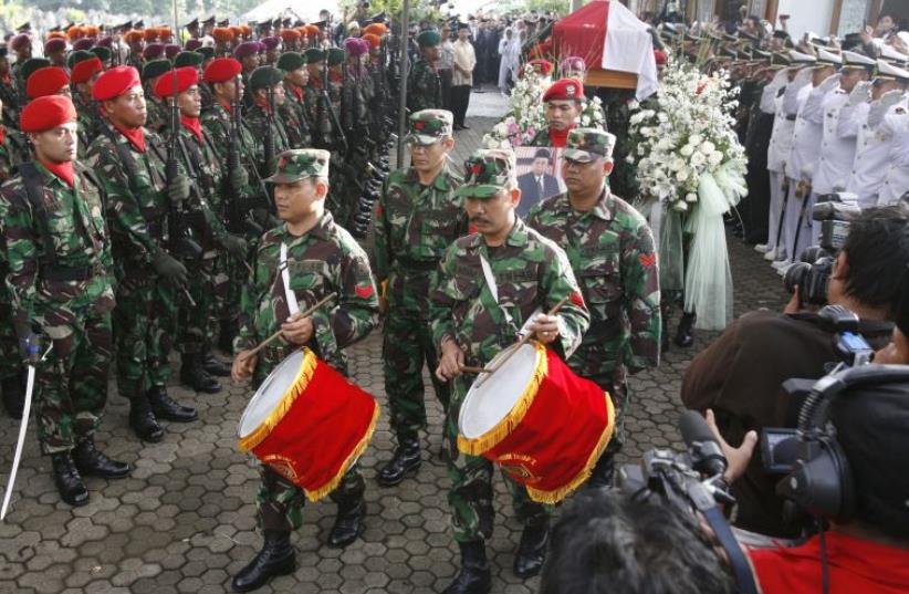 Soldiers carry the coffin of former Indonesian President Abdurrahman Wahid (also known as Gus Dur) as they leave the residence in Jakarta, December 31, 2009 (photo credit: REUTERS)