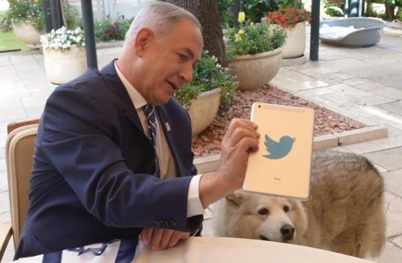 Prime Minister Benjamin Netanyahu answers questions on Twitter (photo credit: GPO/AMOS BEN GERSHOM)