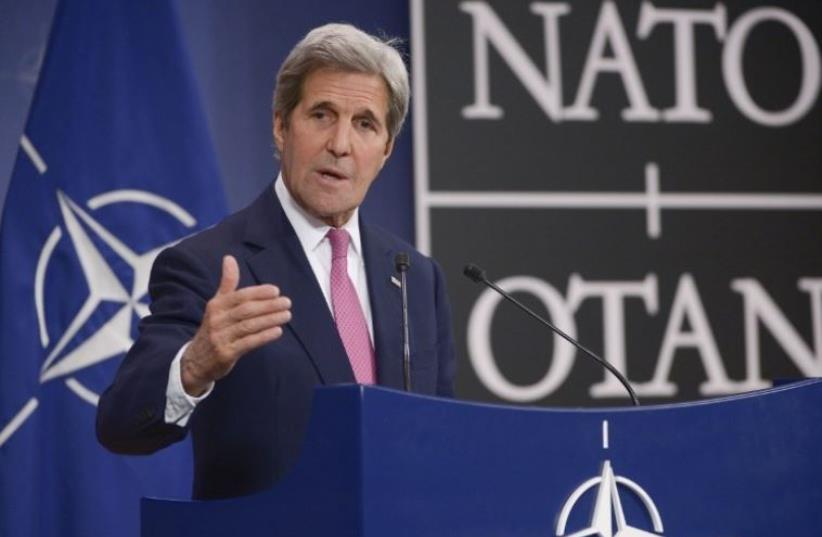 US Secretary of State John Kerry speaks to the press at NATO headquarters in Brussels (photo credit: AFP PHOTO)