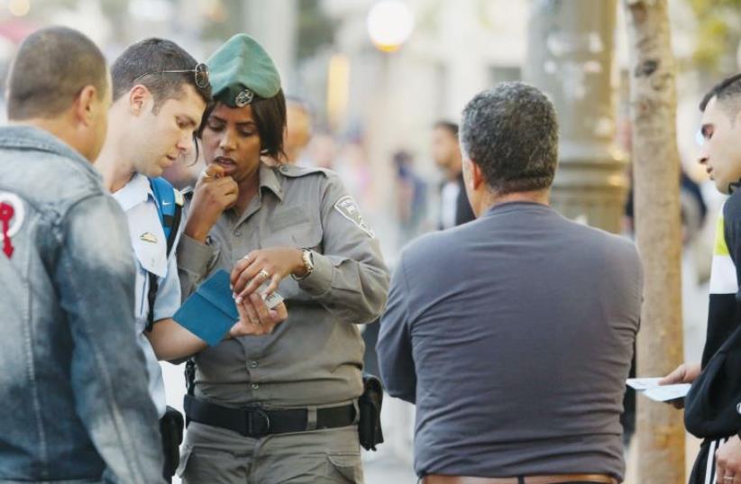 Police check the IDs of Arab men on Jaffa Road in Jerusalem (photo credit: MARC ISRAEL SELLEM)