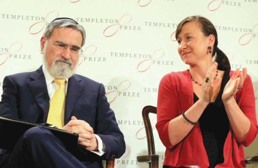 BRITAIN’S FORMER chief rabbi Jonathan Sacks (left) receives applause from Jennifer Templeton Simpson, granddaughter of John Templeton, after being awarded the 2016 Templeton Prize in London in March. (photo credit: PAUL HACKETT/REUTERS)