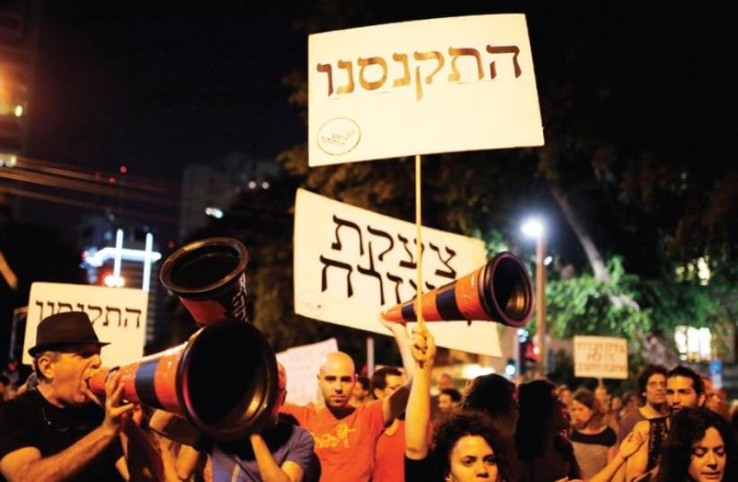 Israelis take part in a demonstration against austerity measures in Tel Aviv in 2013 (photo credit: REUTERS)