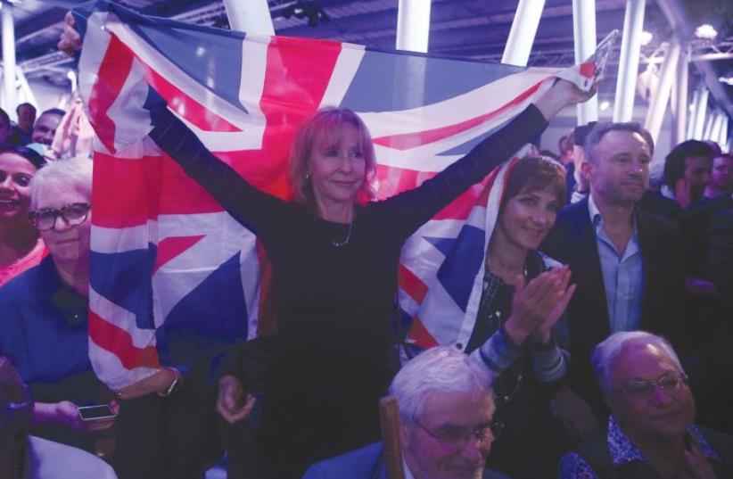 A ‘BREXIT’ SUPPORTER holds a Union Jack at a Vote Leave rally in London earlier this month. (photo credit: REUTERS)