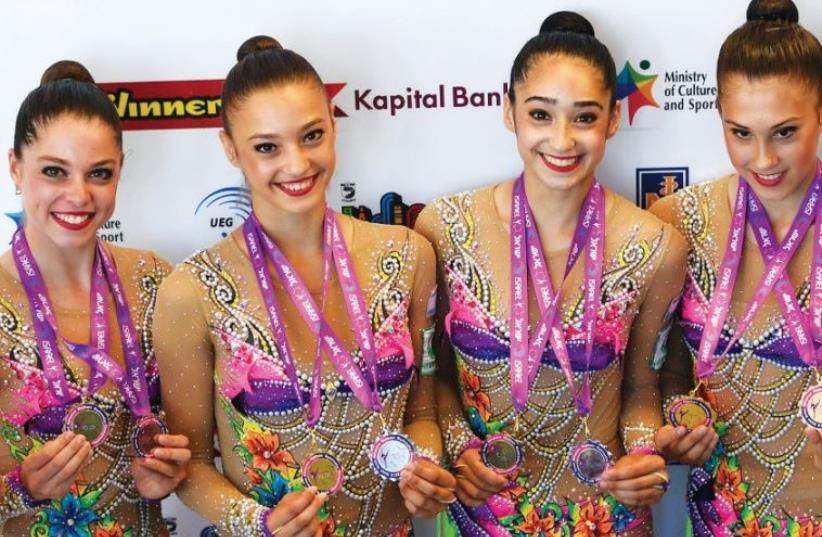 The members of Israel’s rhythmic gymnastics national team were understandably delighted on Sunday after claiming the gold medal in the clubs and hoops final at the European Championships in Holon. (photo credit: AMIT SCHUSSEL)