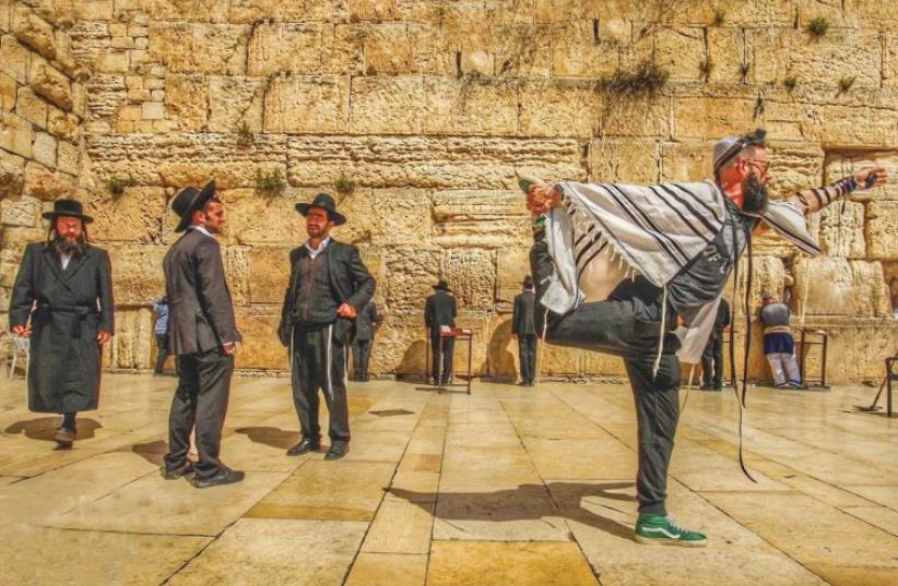 AMERICAN YOGA master Seth Kaufman doing yoga at the Western Wall in Jerusalem. (photo credit: ROBERT STURMAN)