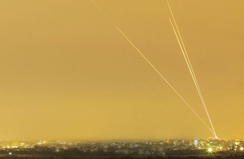 Smoke trails are seen as rockets are launched towards Israel from the northern Gaza Strip (photo credit: REUTERS)