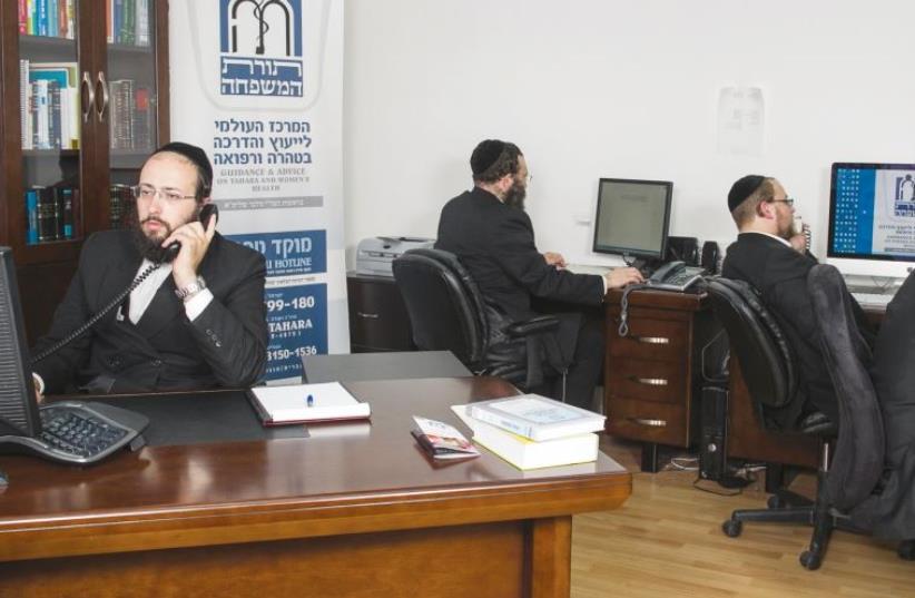 Rabbi Yitzchak Melber (left) and volunteers answer the Tahareinu hotline, fielding questions on Halacha and reproductive health (photo credit: COURTESY TAHAREINU)