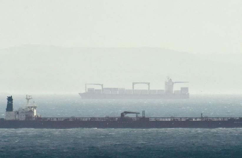 CARGO SHIPS are seen as they sail across the English Channel from Dover in Britain, with the French coast on the horizon. (photo credit: REUTERS)